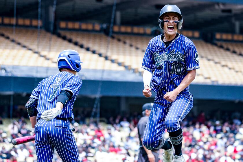 Nick Park of North Hollywood leaps for joy in the eighth inning at Dodger Stadium. 