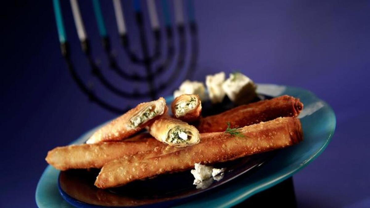 Cheese cigars are dill-flavored feta wrapped in thick filo dough and fried.