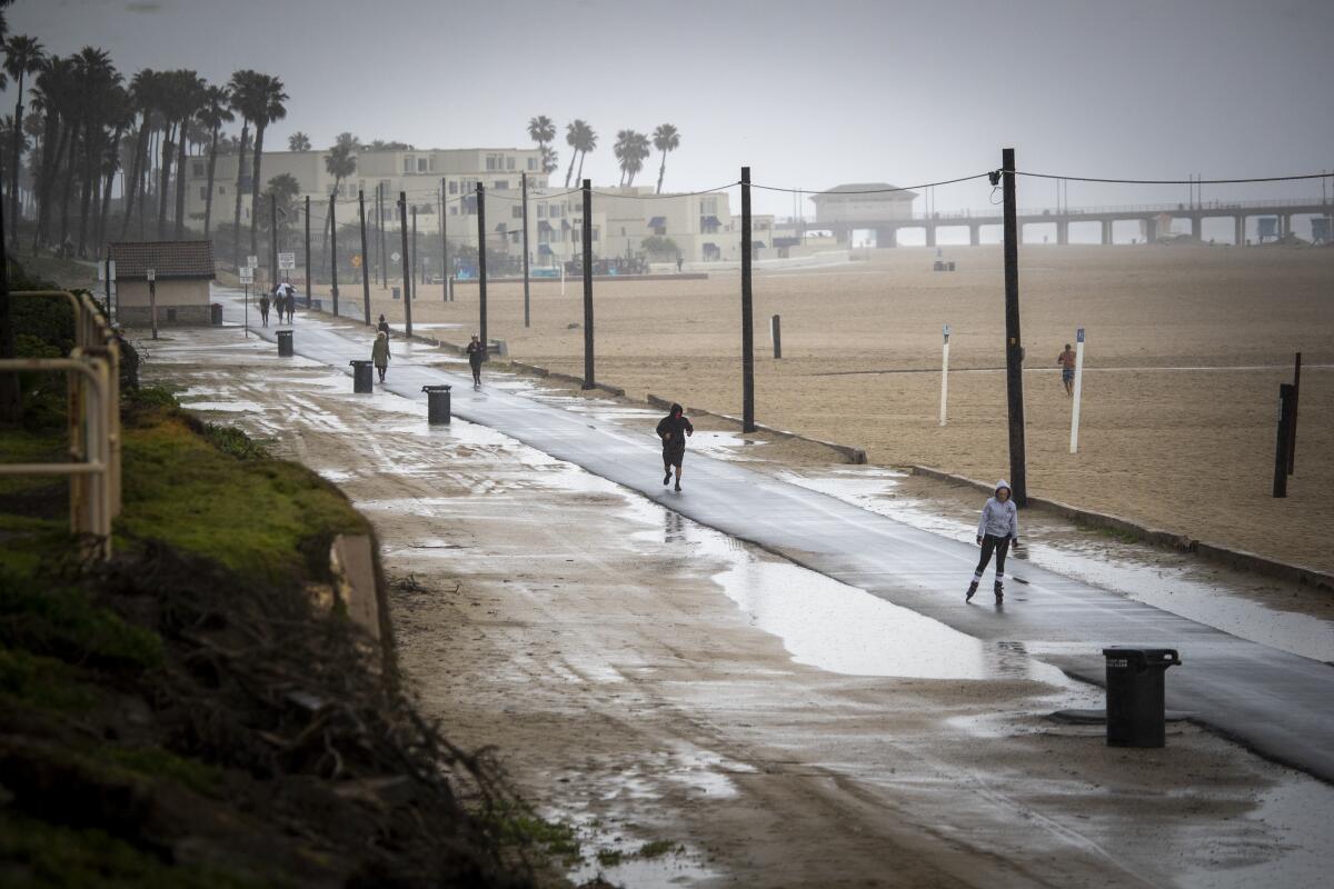 People exercise on a bike path in Huntington Beach on Friday.