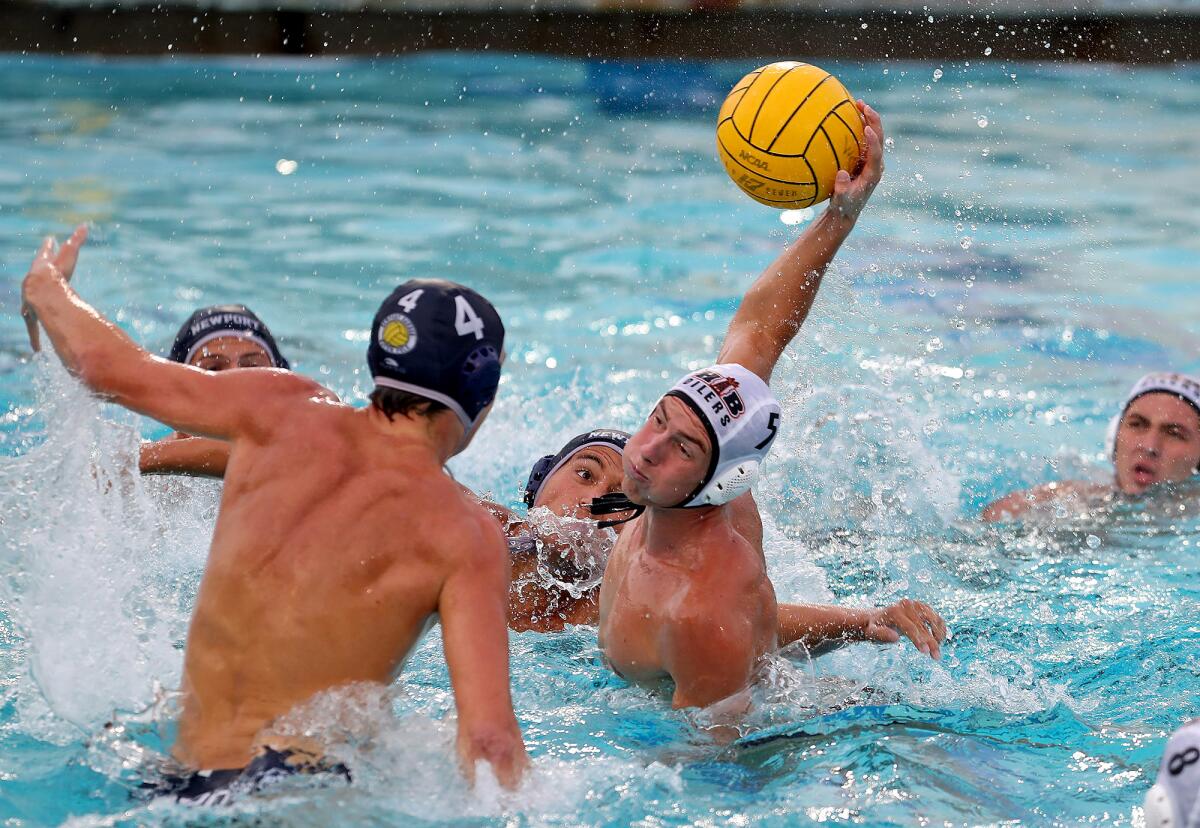 Tas Palcza (5) of Huntington Beach takes a quick pass and scores in front of the net against Newport Harbor on Wednesday.