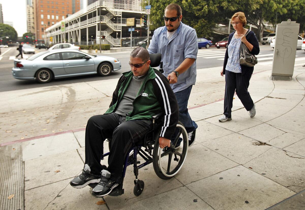 A wheelchair-bound Bryan Stow with his mother, right, enters the courthouse in downtown L.A. on May 28.