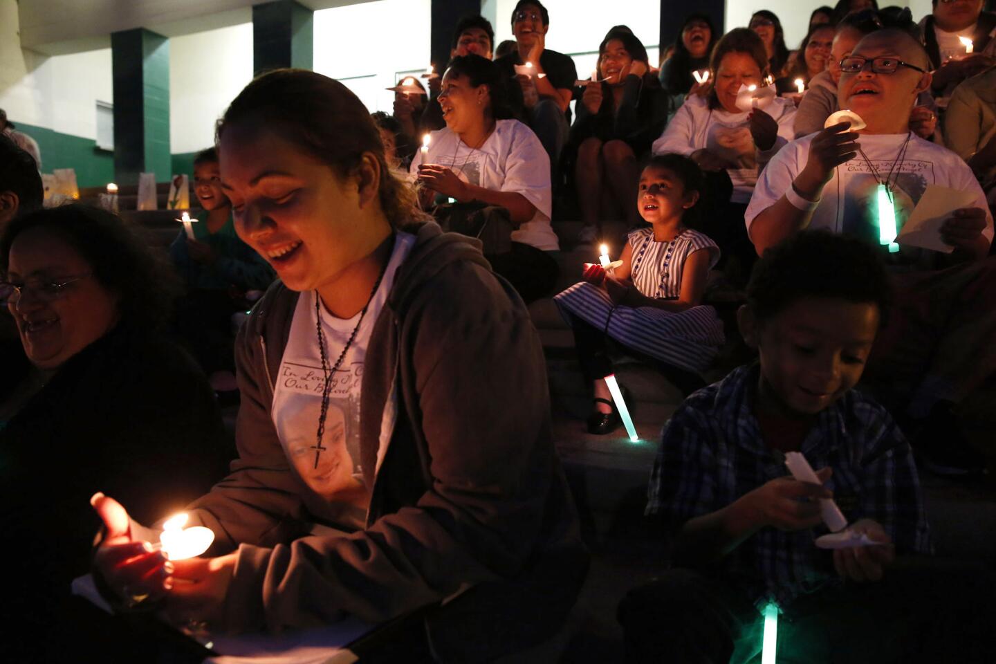 Hailey Ordonez, 4, center, sits with other family members during a rousing candlelight vigil for her aunt, Dorsey High student Jennifer Bonilla, one of the 10 killed in last week's bus crash in Orland.