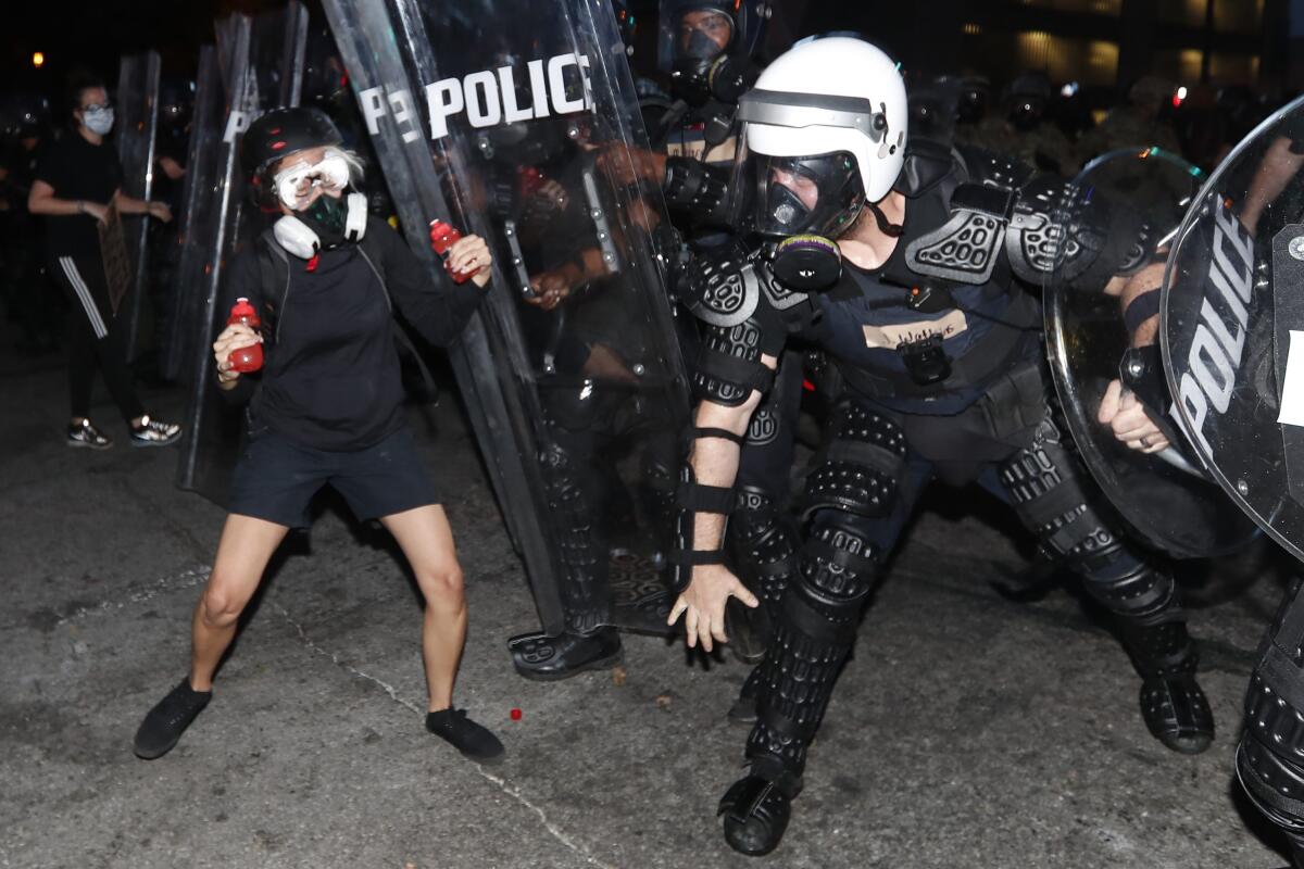 Atlanta police clash with a demonstrator.