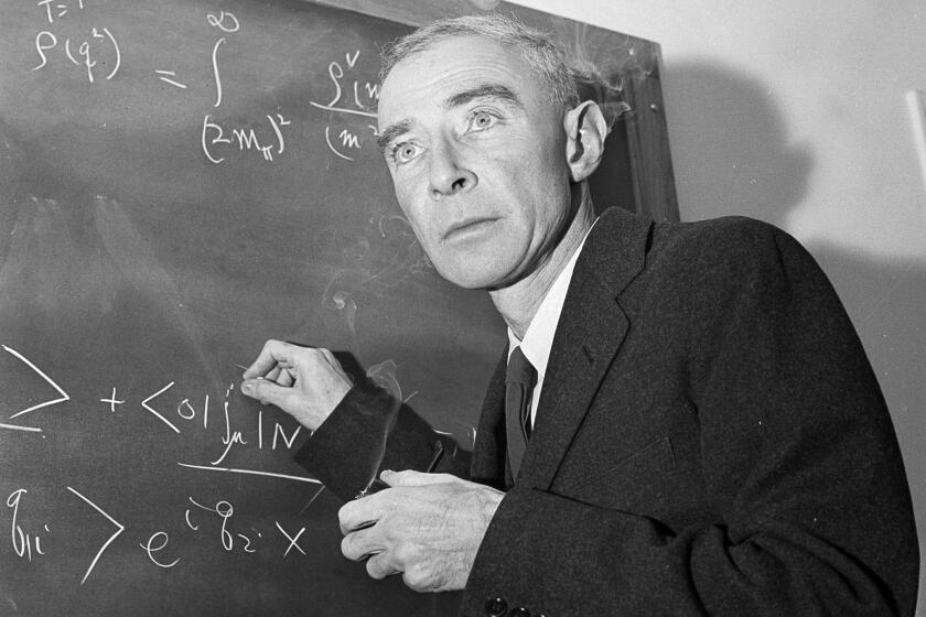 FILE - Dr. J. Robert Oppenheimer, creator of the atom bomb, is shown at his study in Princeton University's Institute for Advanced Study, Princeton, N.J., Dec. 15, 1957. The Biden administration has reversed a decades-old decision to revoke the security clearance of Oppenheimer, the physicist called the father of the atomic bomb for his leading role in World War II’s Manhattan Project. (AP Photo/John Rooney, File)