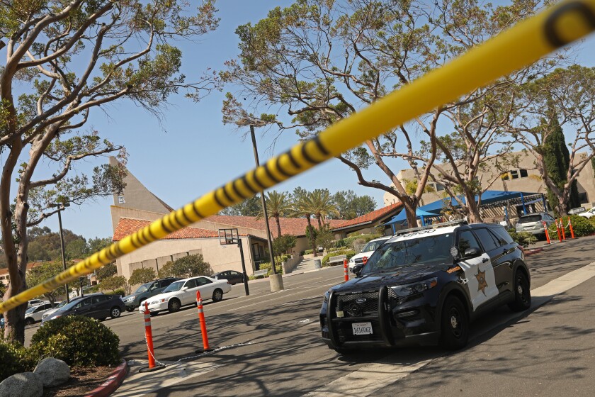 A police vehicle is seen Monday outside Geneva Presbyterian Church in Laguna Woods, the scene of a shooting on Sunday.