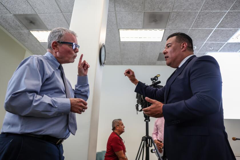 Los Angeles, CA, Tuesday, September 17, 2024 - Insurance Commissioner Ricardo Lara, right, talks with homeowner Bruce Breslau following a legislative oversight hearing held by the state insurance commissioner at LA City Hall. Breslau testified that his homeowner association is enduring massive rate hikes after Lara addressed the committee updating his plans for reform. (Robert Gauthier/Los Angeles Times)