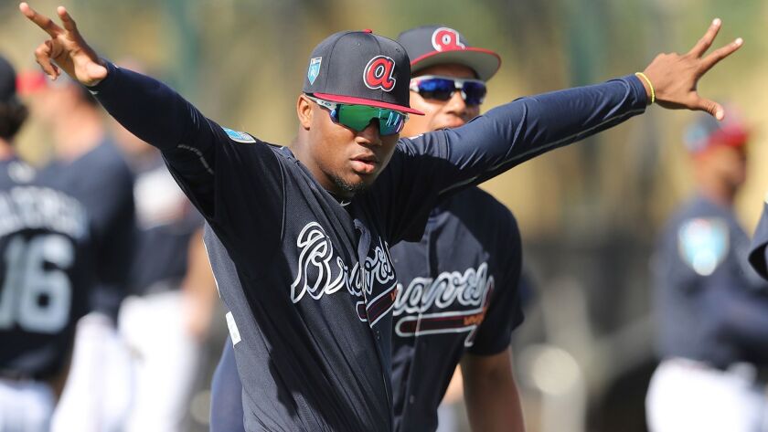 Atlanta Braves prospect, outfielder Ronald Acuna, loosen up at baseball spring training in Kissimmee, Fla., Tuesday, Feb. 20, 2018.