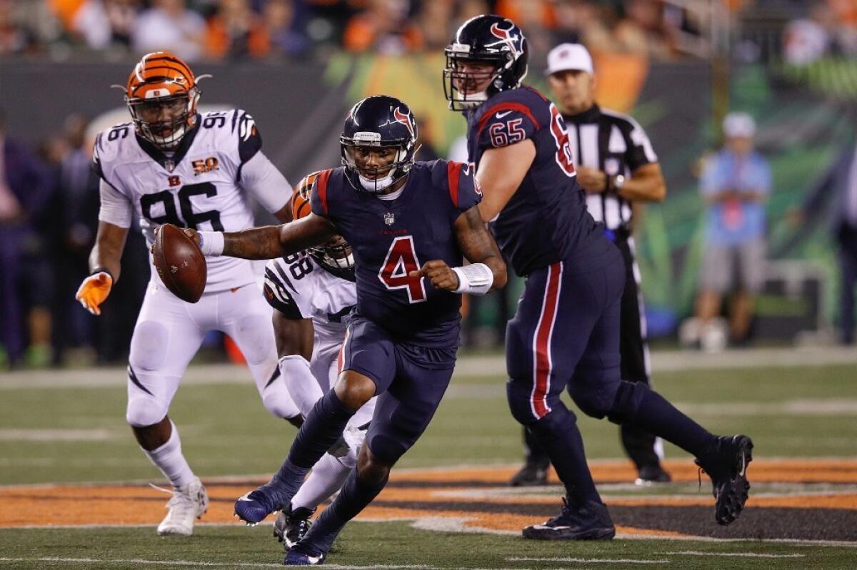 Texans quarterback Deshaun Watson scrambles with the ball during the second half of a game against the Cincinnati Bengals on Thursday.