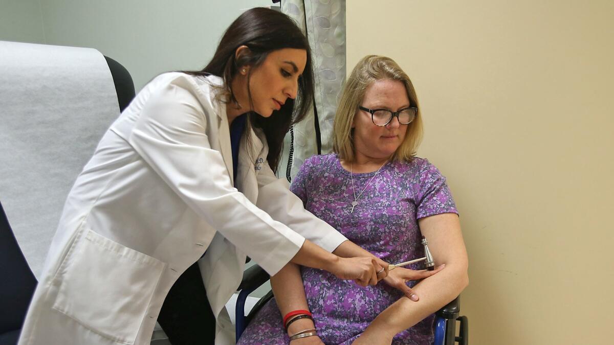 Dr. Namita Goyal, a UC Irvine neurologist, and patient Lisa Wittenberg work through a series of reflex tests. Wittenberg and Goyal are part of a nationwide study on ALS with UC Irvine.