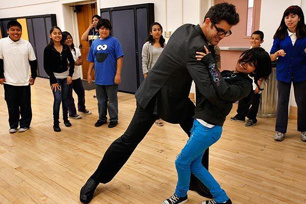 Dance instructor Danny Ponickly dips Danna Pelaez, 12, as other students watch during lessons at Breed Street Elementary School in Boyle Heights. The program is run by Ballroom Madness, a local nonprofit organization fashioned after American Ballroom Theater, the New York group whose work in schools was featured in the 2005 movie "Mad Hot Ballroom."