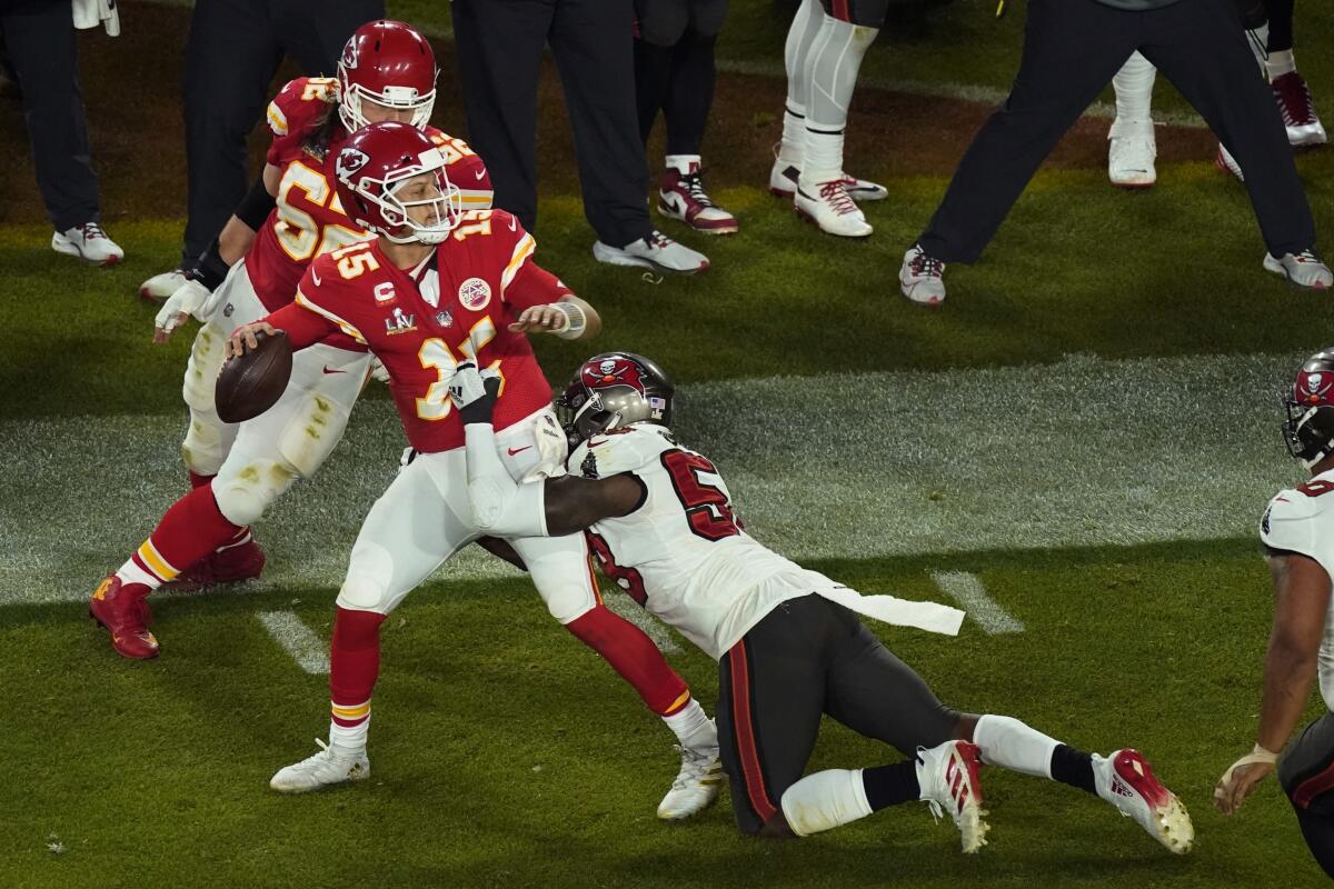 Kansas City quarterback Patrick Mahomes is pressured by Tampa Bay's Shaquil Barrett.