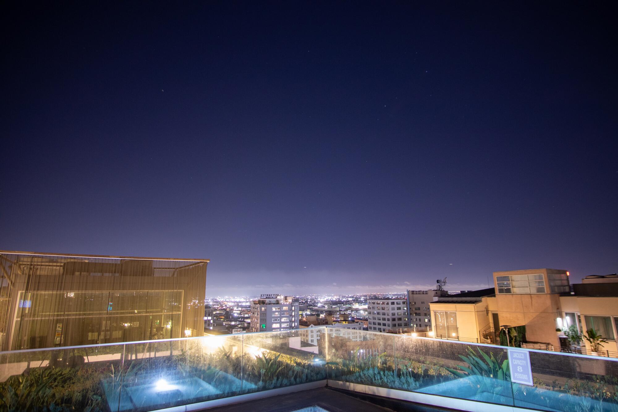 Lights from buildings in downtown Los Angeles wash out most stars in the night sky.