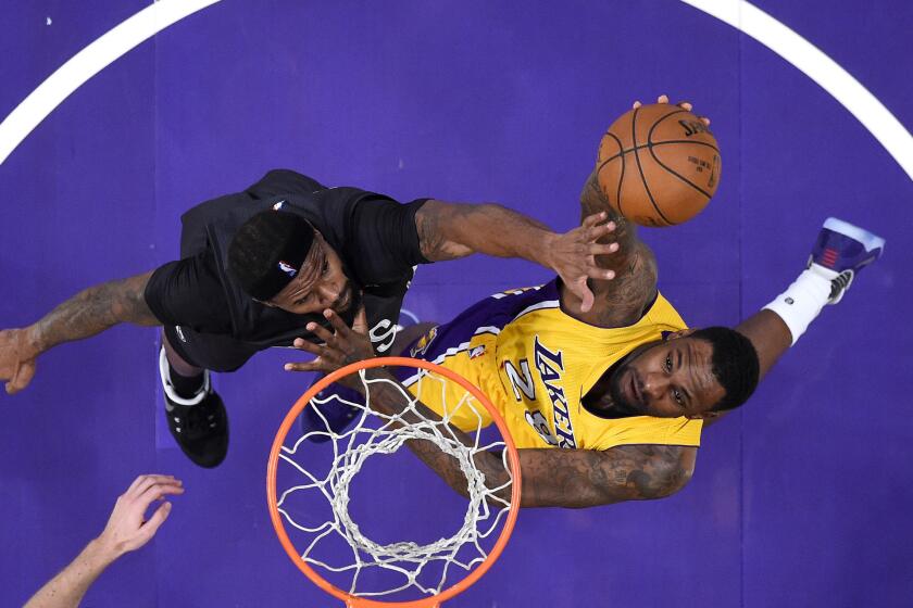 Lakers' Tarik Black shoots against Brooklyn's Trevor Booker on Nov. 15.