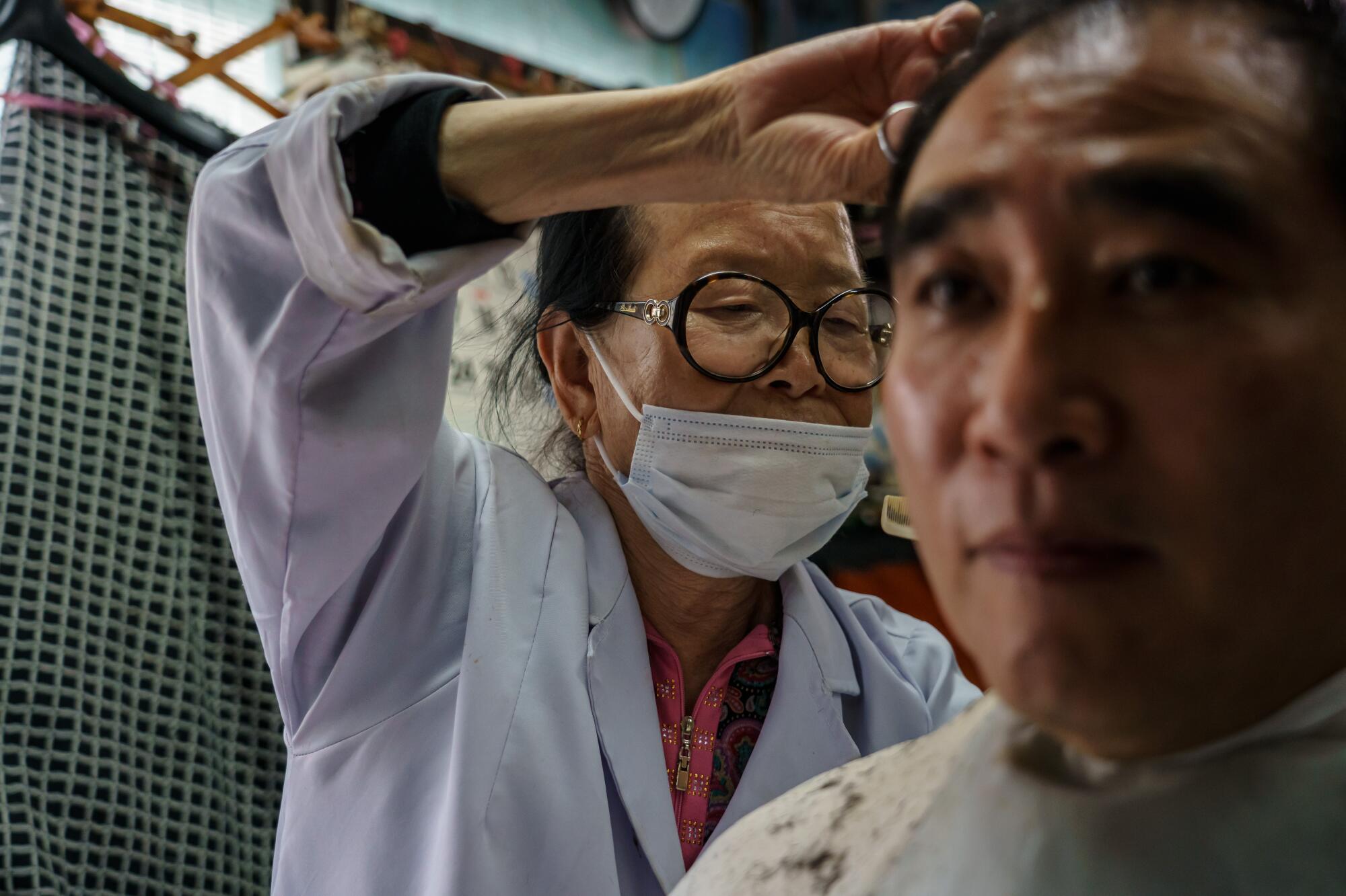 Lee Duk-hoon at work at her Seoul barbershop