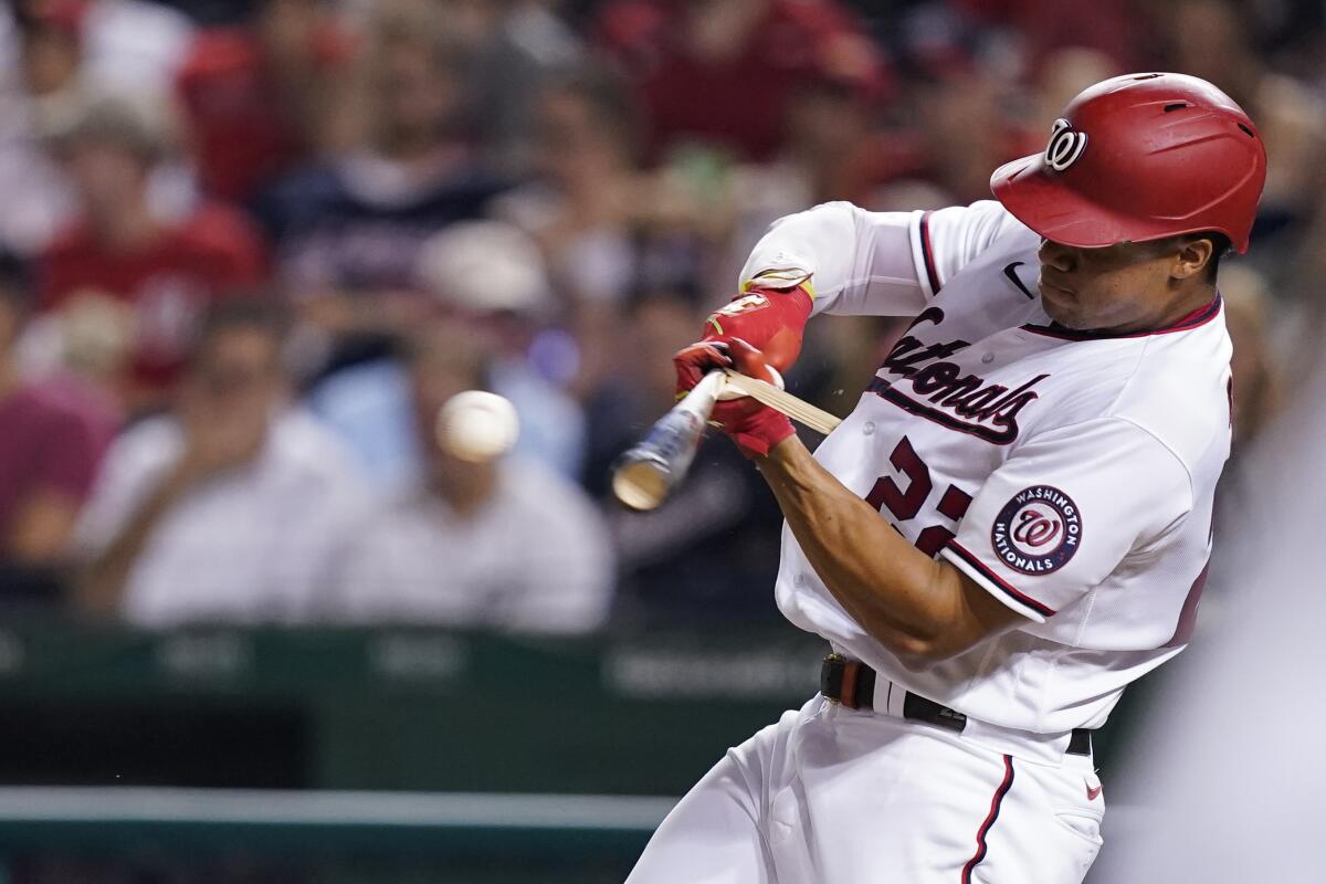 Washington Nationals' Juan Soto hits an RBI double, and reaches third on an error, during the third inning of a baseball game against the Miami Marlins at Nationals Park, Tuesday, Sept. 14, 2021, in Washington. (AP Photo/Alex Brandon)