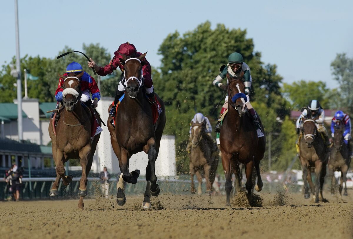 Shedaresthedevil crosses the finish line ahead of Swiss Skydiver, left, and Gamine to win.