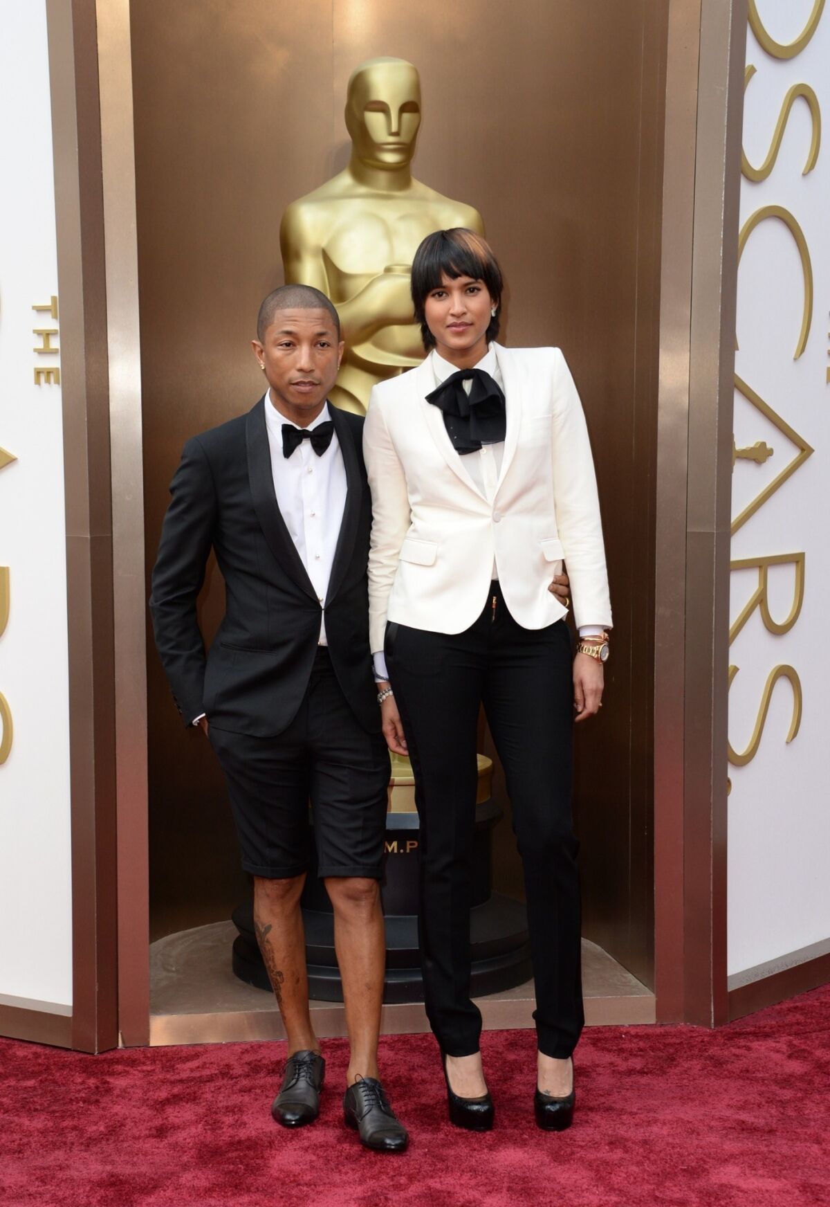Pharrell Williams, wearing a Lanvin shorts tuxedo, and Helen Lasichanh.