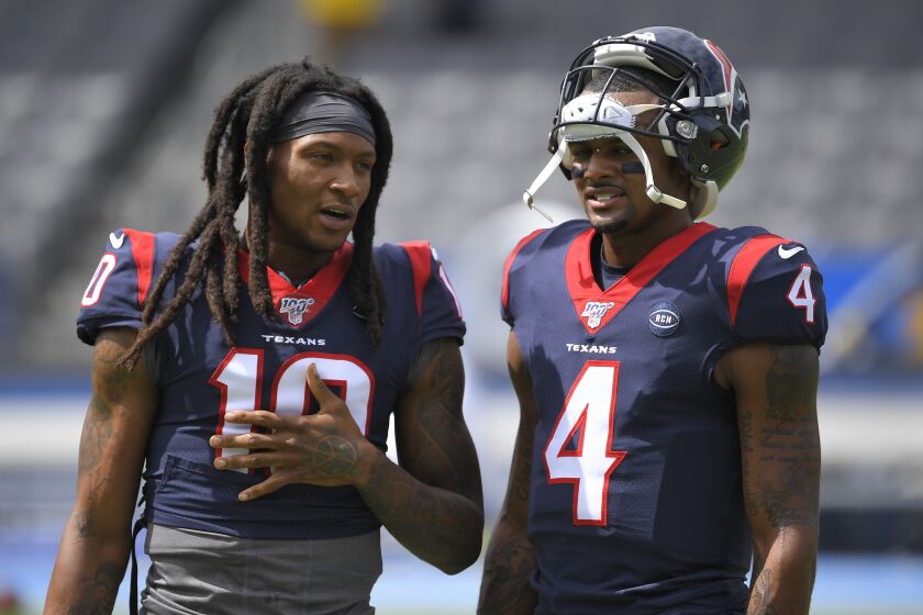 FILE - Houston Texans wide receiver DeAndre Hopkins. left, talks with quarterback Deshaun Watson before an NFL football game against the Los Angeles Chargers Sunday, Sept. 22, 2019, in Carson, Calif. Watson , now with the Cleveland Browns, said Tuesday, May 30, 2023, that he has spoken to Hopkins, his close friend and former Houston teammate, and encouraged the five-time Pro Bowl wide receiver to consider a reunion. Hopkins is a free agent after the Arizona Cardinals released him last week. (AP Photo/Mark J. Terrill, File)