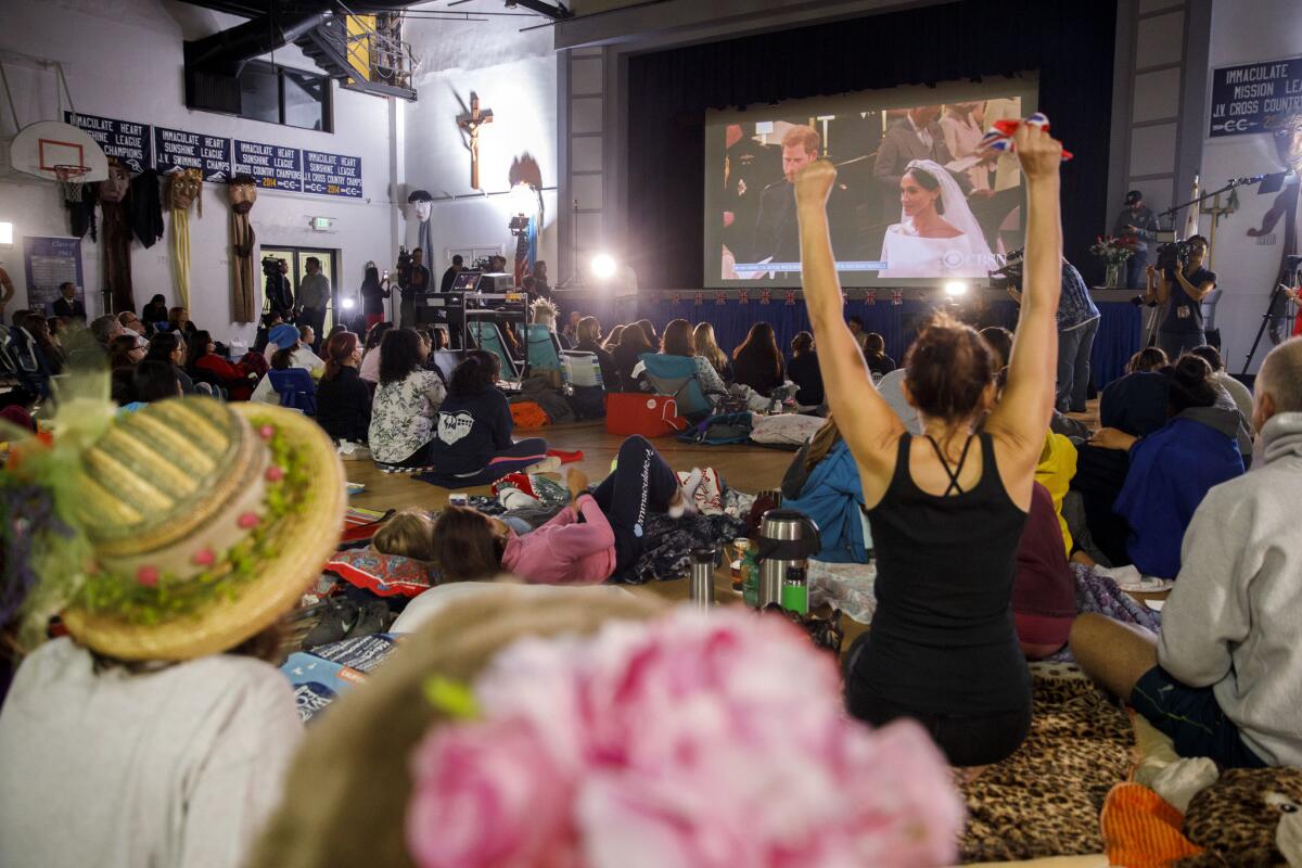 Students and parents watch a broadcast of the wedding at Immaculate Heart High School.