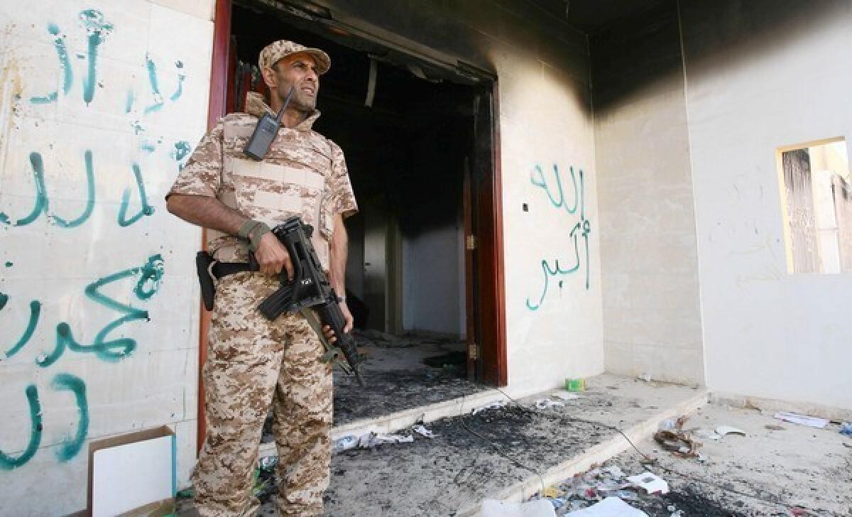 A Libyan military guard stands in front of one of the U.S. Consulate's burned out buildings in Benghazi, Libya, a few days after the attack on the compound.