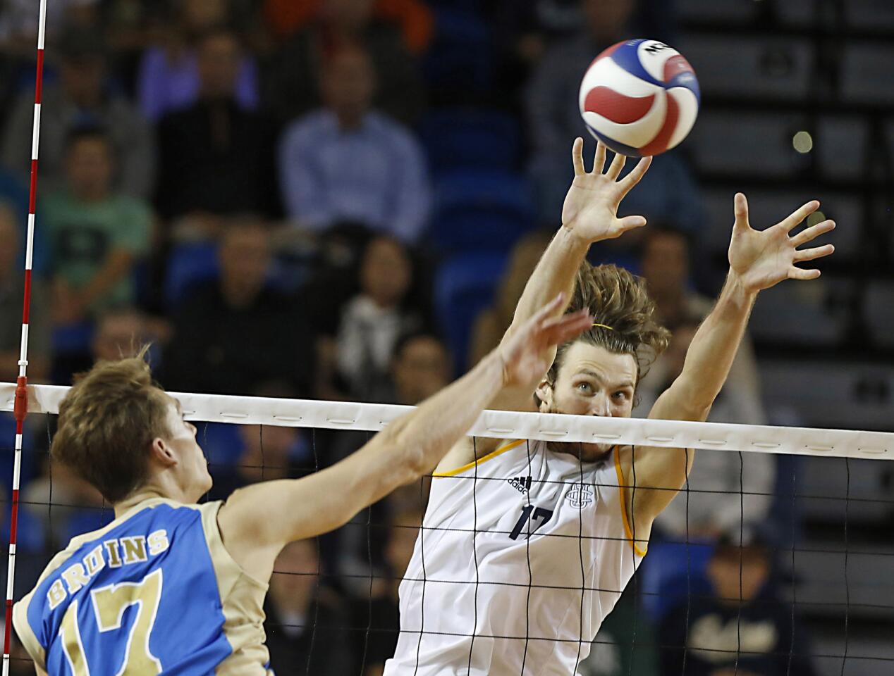 UC Irvine's Zack La Cavera challenges UCLA's Christian Hessenauer at the net in a volleyball match at UC Irvine on Saturday. UCI won 3-0.