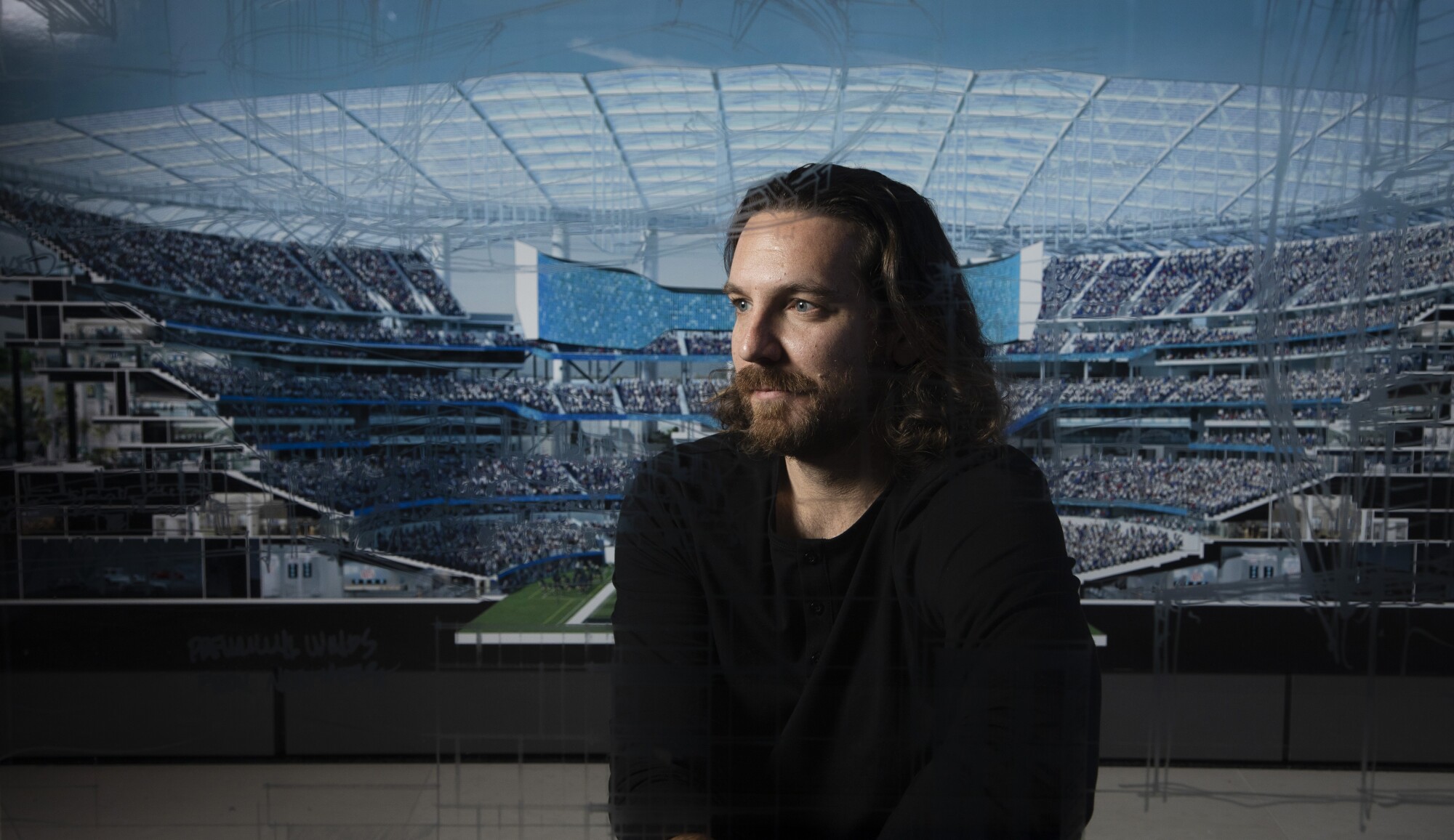 Architect Lance Evans sits before a projection of SoFi Stadium in his firm's Westwood office.