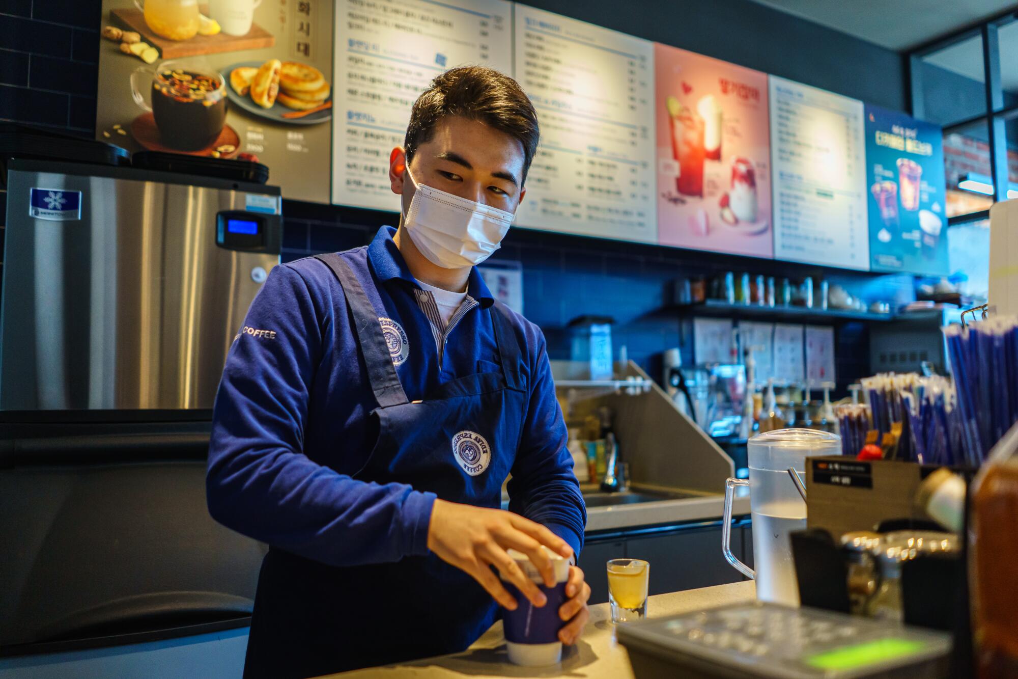 JA man working at a coffee shop