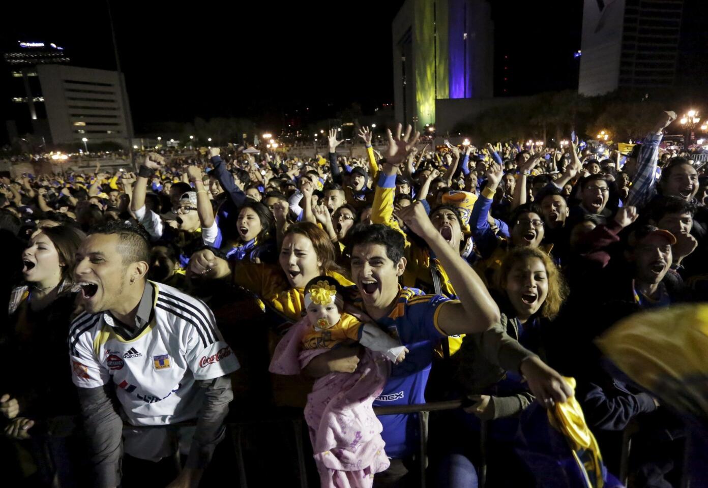 Football Soccer - Pumas v Tigres - The second leg of their Mexican first division final soccer match - Fans of Tigres cheer as they watch the match on a big screen during a public viewing event in Monterrey, Mexico - 14/12/15 REUTERS/Daniel Becerril ** Usable by SD ONLY **