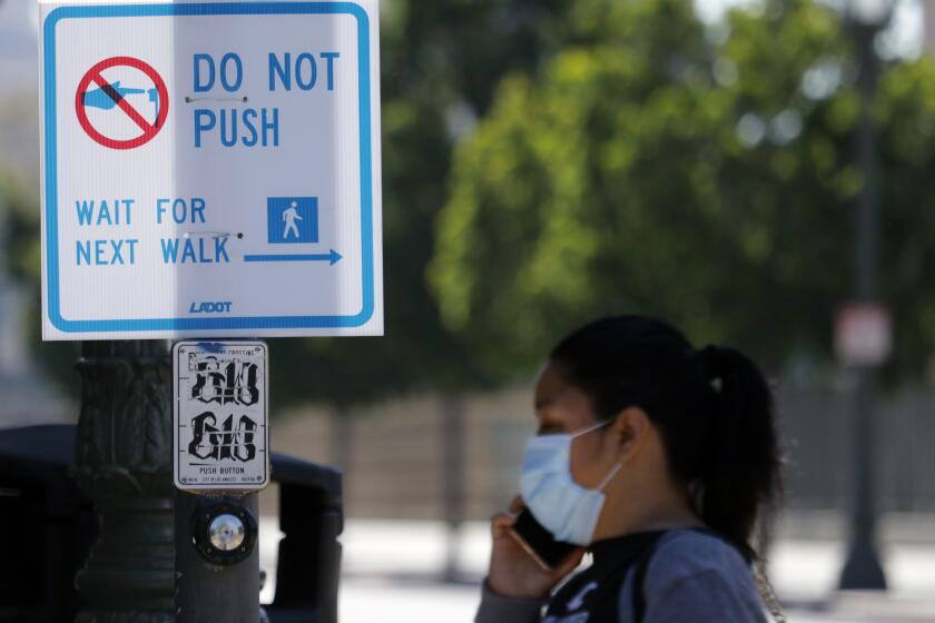 LOS ANGELES, CA - APRIL 16, 2020: No-touch signs for signal lights have been installed in Los Angeles as a way of reducing the spread of the coronavirus. (Myung J. Chun / Los Angeles Times)