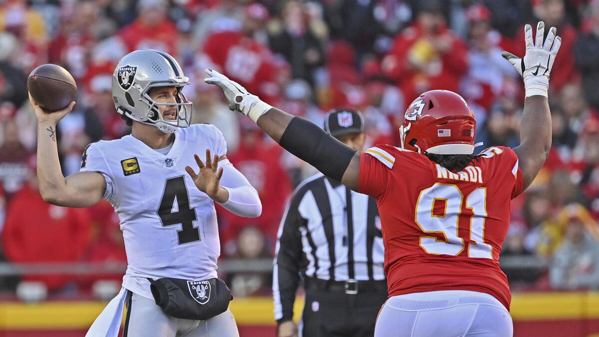 Raiders quarterback Derek Carr throws a pass in front of Chiefs defensive tackle Derrick Nnadi on Sunday.