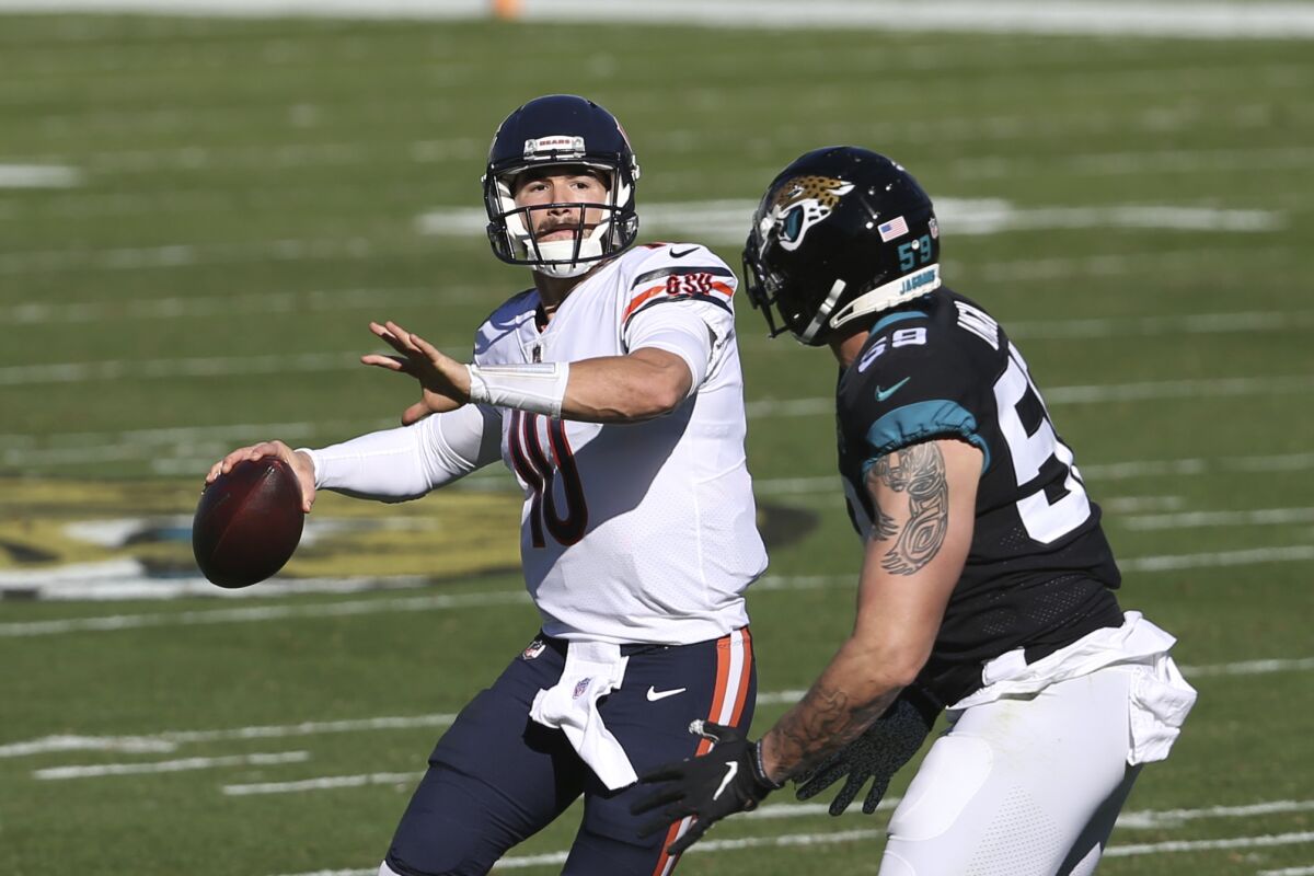 Chicago Bears quarterback Mitchell Trubisky, left, looks to pass in front of Jacksonville Jaguars defensive end Aaron Lynch.