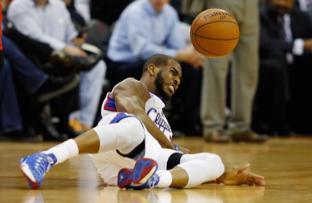 Clippers point guard Chris Paul hits the deck after being tripped up.