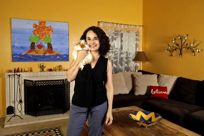 Actress Diane Franklin and her pet guinea pig in her sunny yellow living room.