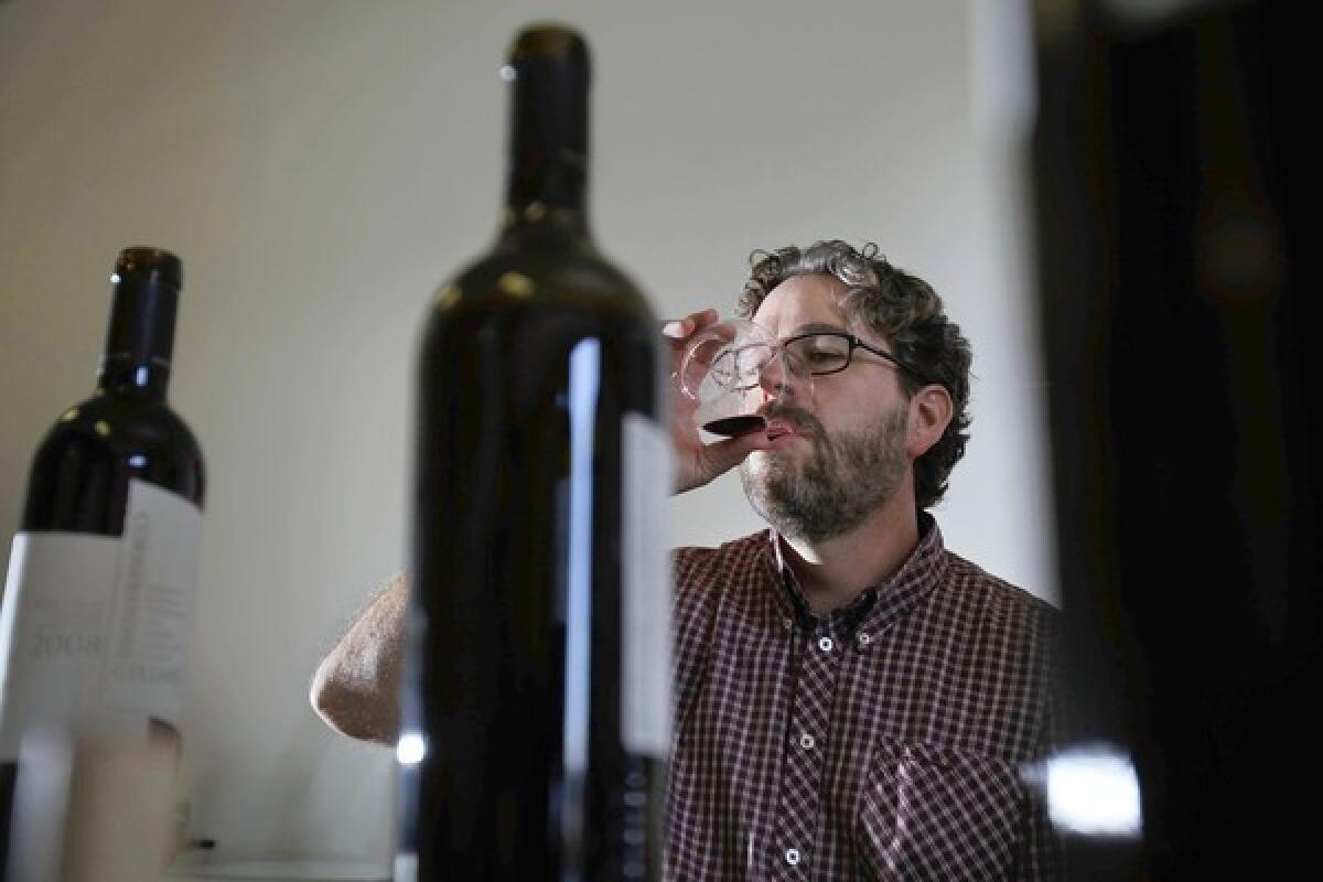 Kyle Meyer does a tasting of wine from Cornerstone Cellars in the makeshift office of his soon-to-open business in Santa Ana.