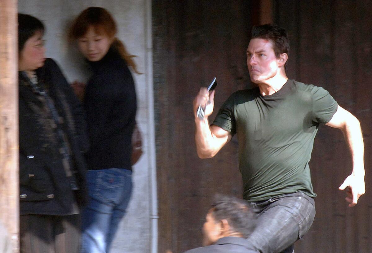 Tom Cruise in the film "Mission Impossilbe 3" staged in the ancient town of Xitang in Jiashan County, east China's Zhejiang Province, Saturday, Nov. 26, 2005.