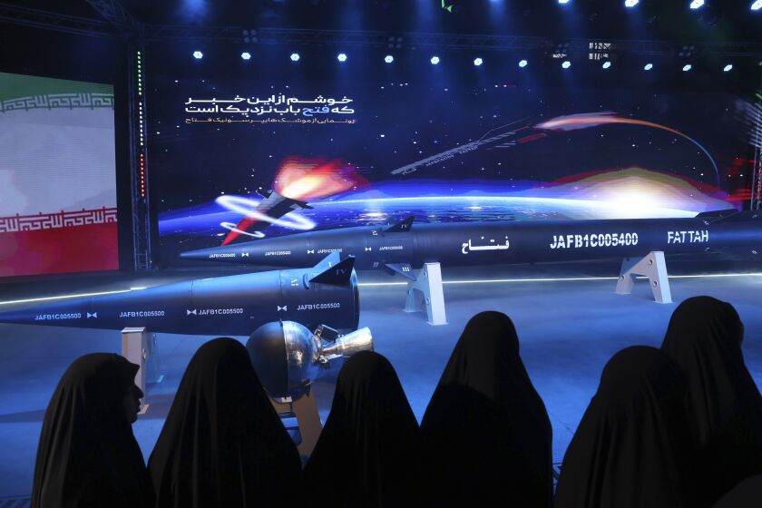 Women look at Fattah missile in a ceremony in Tehran, Iran, Tuesday, June 6, 2023. Iran is claiming that it's created a hypersonic missile capable of traveling at 15 times the speed of sound. The announcement comes as tensions are high with the United States over Tehran's nuclear program. (Hossein Zohrevand/Tasnim News Agency via AP)