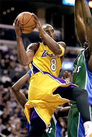 Kobe Bryant goes up for 2 of his 32 first-half points against the Dallas Mavericks at the Staples Center Tuesday. He ended the night with 62 points.