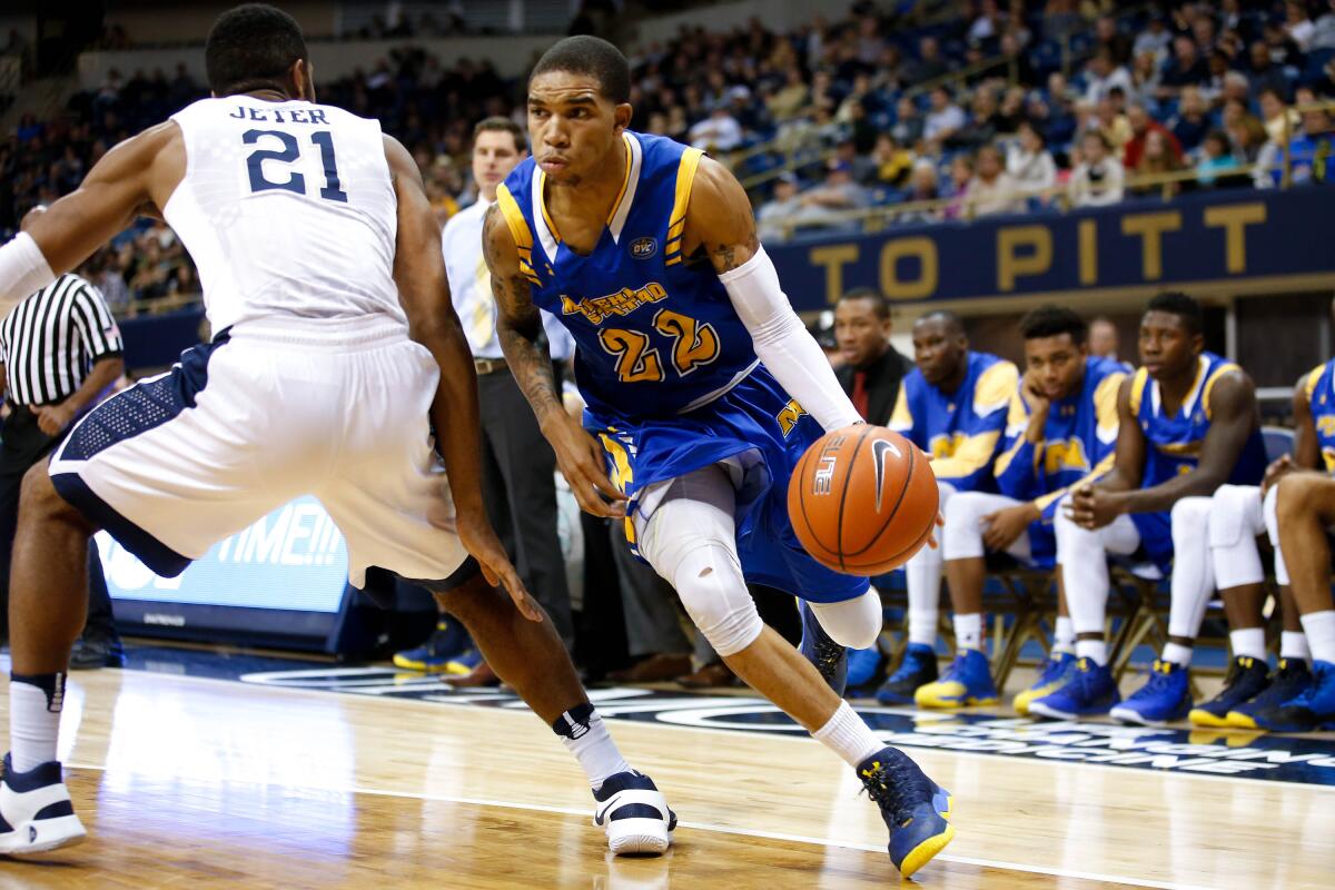 Morehead State guard Xavier Moon (22) drives to the basket past Pittsburgh forward Sheldon Jeter (21).