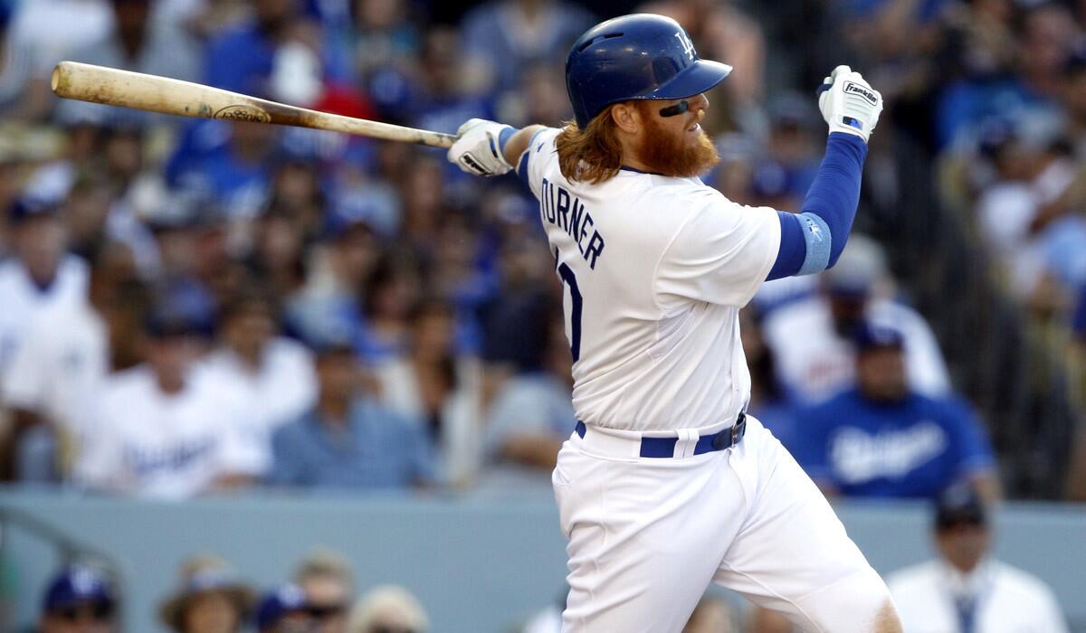 The Dodgers' Justin Turner hits a run-scoring single against the San Francisco Giants at Dodger Stadium on June 21.