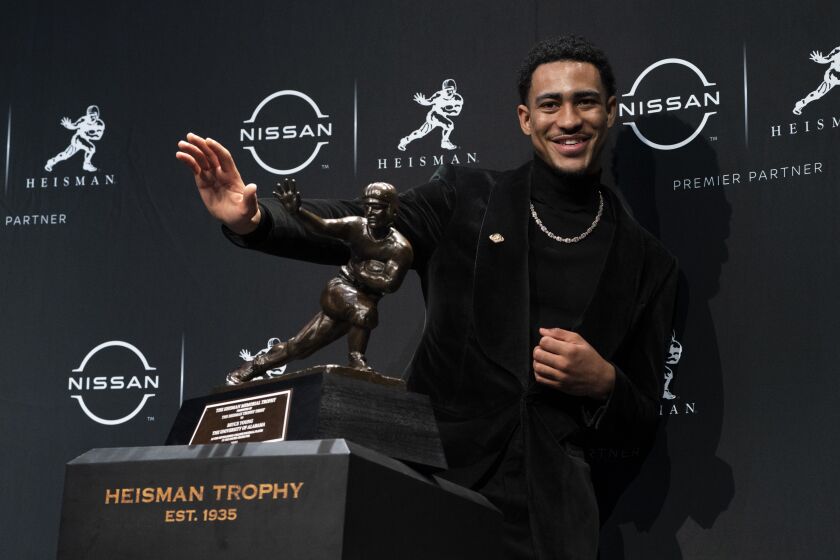 Alabama quarterback Bryce Young poses for a photograph after winning the Heisman Trophy.