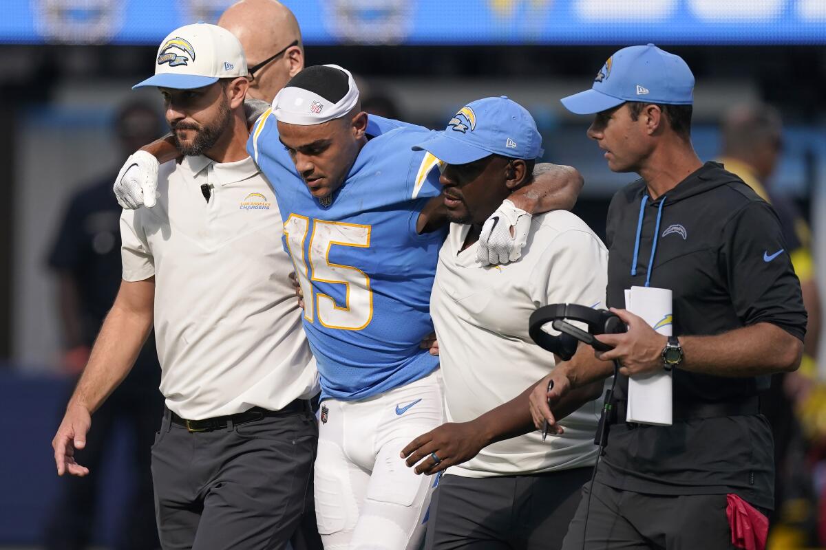 Chargers wide receiver Jalen Guyton (15) is helped off the field after injuring his knee against the Jacksonville Jaguars.