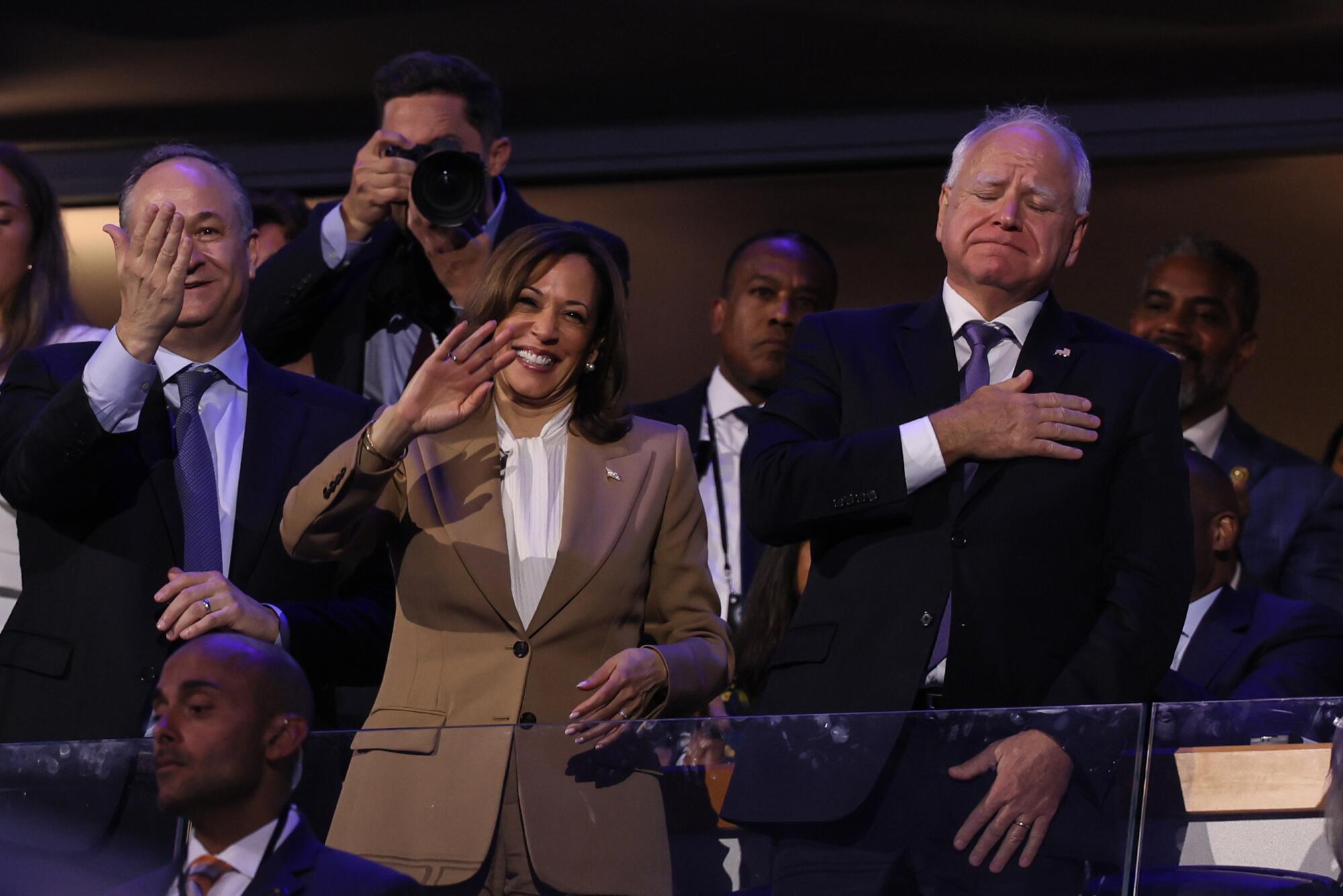 Tim Walz tears up standing with Kamala Harris and Doug Emhoff.