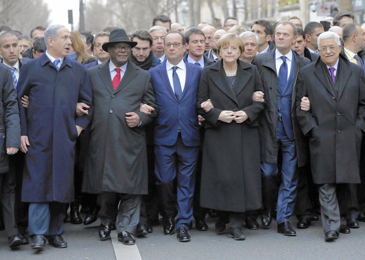 French President Francois Hollande (third from the left) is surrounded by head of states as they march through Paris on Jan. 11.