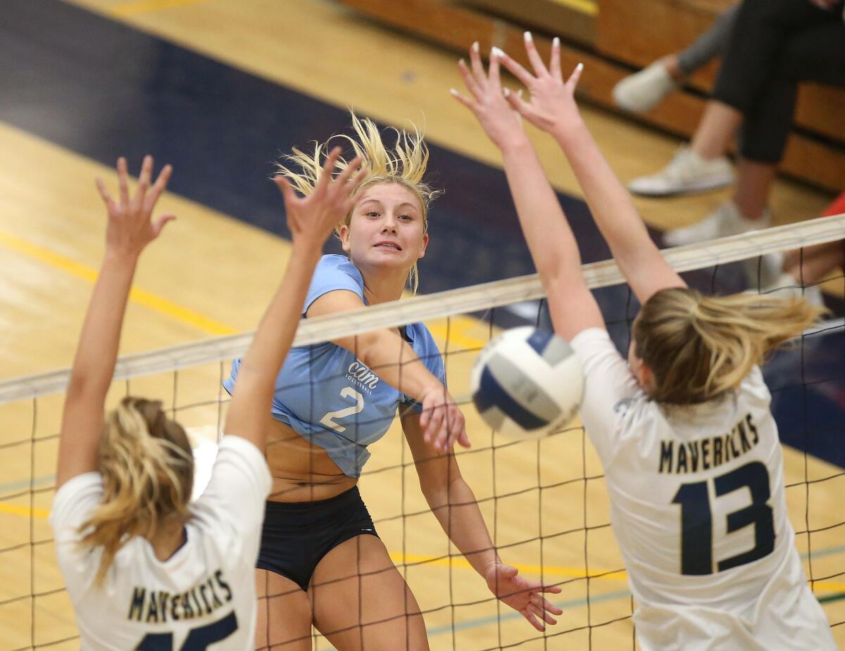 Corona del Mar outside hitter Nikki Senske (2) puts the ball past La Costa Canyon blockers Eva Rohrbach, left, and Avry Tatum in the quarterfinals of the CIF State Southern California Regional Division I playoffs on Thursday in Carlsbad.