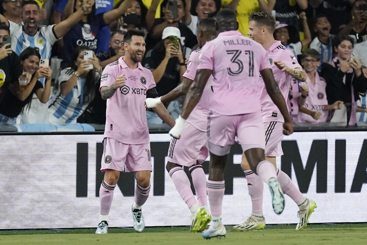 Inter Miami forward Lionel Messi, left, celebrates after scoring against Nashville SC in the first half Saturday of the Leagues Cup final.