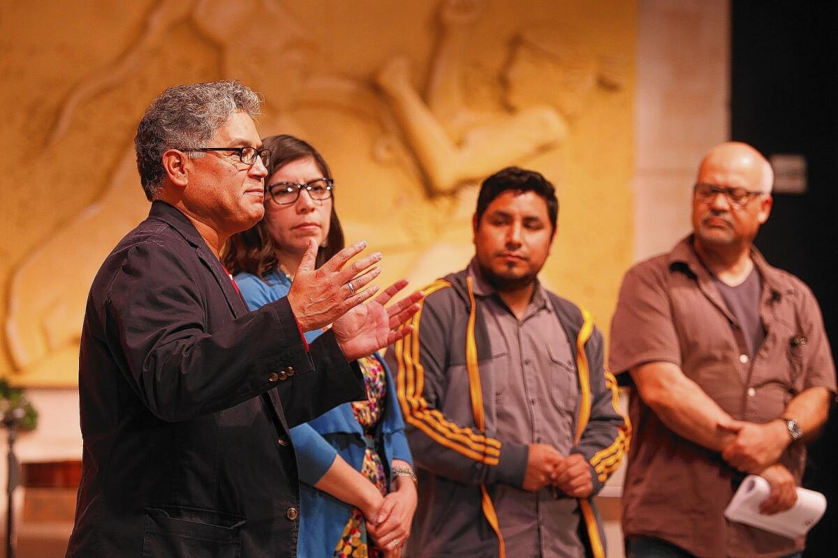 From left, "The Long Road Today" playwright Jose Cruz Gonzalez, project director Sara Guerrero, Moises Vazquez of Latino Health Access and play director Armando Molina address the audience before Santa Ana community members took the stage during a reading at Santa Ana College.
