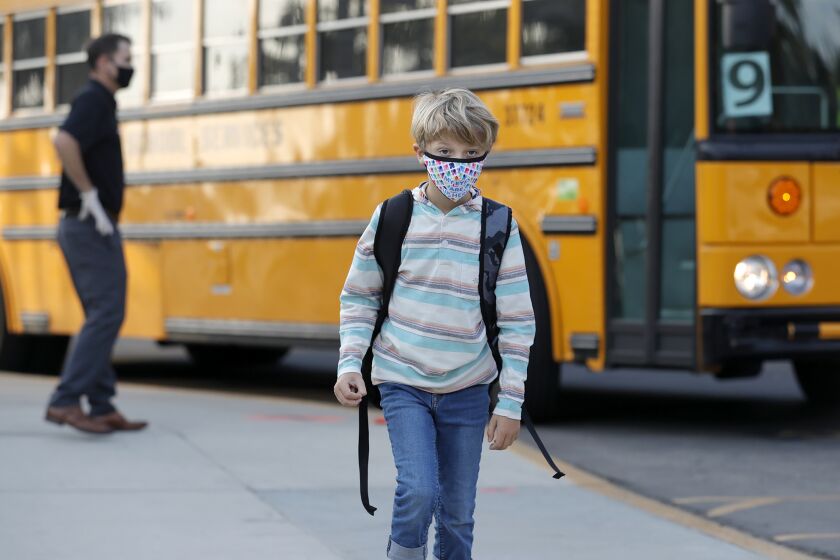 A student arrives on the bus as kids return for in-person learning at Top of the World elementary as part of the Laguna Beach Unified School District's hybrid learning model.