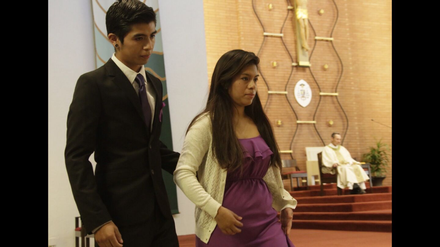 Josafat Gonzalez, 21, and Brenda Gonzalez, 24, return to their seats after speaking at the funeral of their 13-year-old sister Andrea at Holy Family Cathedral in Orange. Gonzalez and two other girls were stuck and killed by a hit-and-run driver while trick-or-treating on Halloween night.