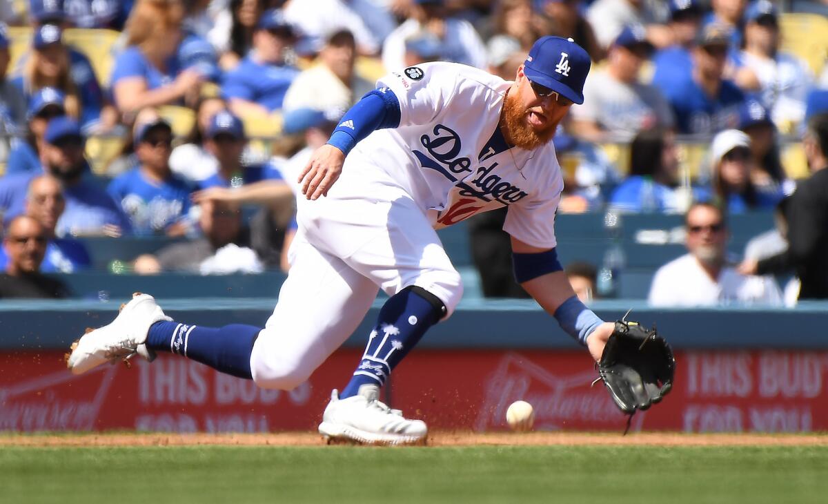 Dodgers third baseman Justin Turner fields a ball during Thursday's 12-5 season-opening victory over the Arizona Diamondbacks.