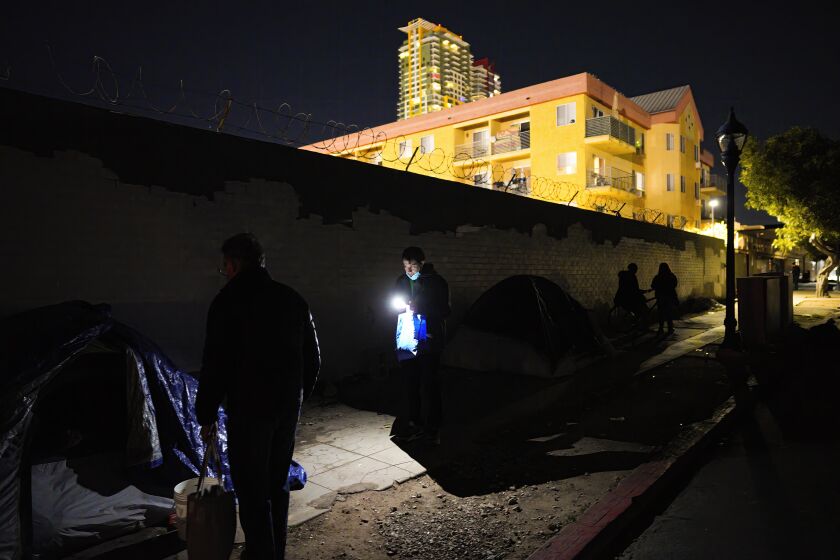 San Diego, CA - January 26: Working in the East Village, Scott Manning (l) and Jesus Montes (r) were among the volunteers working on Thursday, Jan. 26, 2023 before sunrise in San Diego, CA., for the annual point-in-time count taking place in San Diego County. (Nelvin C. Cepeda / The San Diego Union-Tribune)